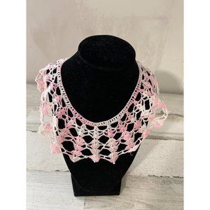 Pink and white crocheted collar with tiny pearls around the edges